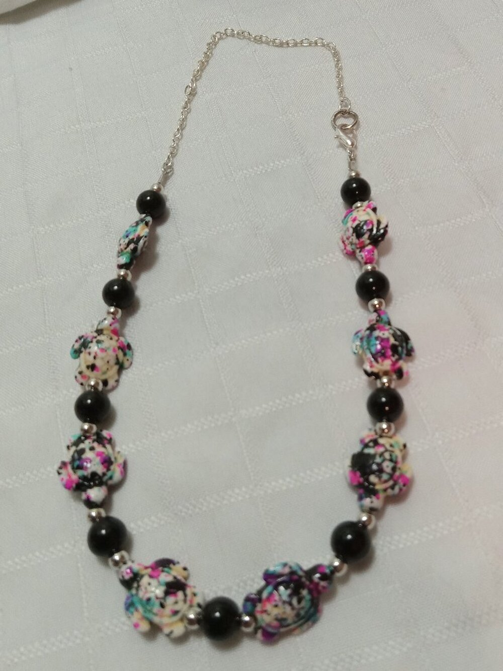 Pretty handmade necklace with little turtles and glass bead